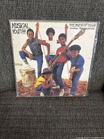 Front cover of Musical Youth vinyl LP album 'The Youth of Today' showing five band members posing with instruments.