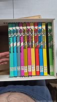 Top down view of the 11 hardcover Air International magazines in a box, showing volume numbers and issue details on the spines.