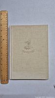Front cover of Fantastic Mr. Fox 1st edition showing beige cloth cover with emblem next to ruler for size reference.