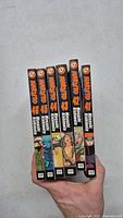 Front view of spines showing Naruto volumes 41-46 held in hand, displaying title, volume numbers, author Masashi Kishimoto, VIZ Media logo