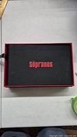 Black inner box with red lettering 'The Sopranos' on lid, showing the main part of the box set.
