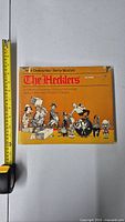 Front cover of The Hecklers political cartoon art book showing caricature cartoon characters and title.