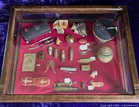 Overall top-down view of vitrine and contents on red velvet