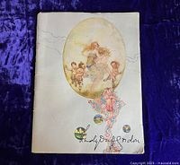 Front cover of the vintage Lady Duff-Gordon 1917 Sears Roebuck fashion catalog showing illustrated woman and cherubs and decorative elements, with signature.