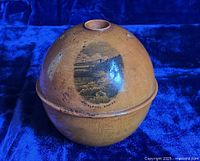 View of the side showing the Whirlpool Rapids scene on the wooden egg-shaped holder.