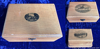Three boxes grouped showing varying sizes and different New York landmark images on lids.