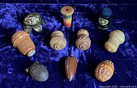Group view of ten thimble holders on velvet background