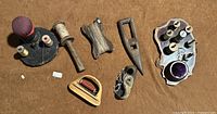 Overview of all rustic handmade tools including two sewing kits, weaving shuttle, twine holders, and Sailor's Palm