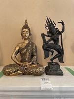 Photo showing both seated Buddha statue and Dancing Shiva statue side by side on a shelf