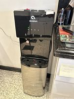 Front and side views of Avalon water cooler showing dispensing taps, LED indicators, control buttons, and stainless steel lower body.