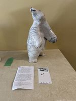 Front three-quarter view of standing polar bear sculpture showing crackle glaze pattern and facial features