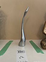 Photo of the Hoselton signed long-necked bird sculpture from a frontal angle showing the full length and slender design.