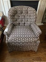 Front view of a brown and white chevron patterned Robert Dirstein design accent armchair, showing overall condition and style.