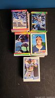 Photo showing stacks of colorful baseball cards from various years and brands with different players on the front.