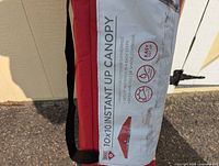 Close-up of the product's packaging label on the carry bag showing key features and dimensions of the canopy.