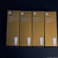 Four boxed bottles of Remedé Invigorate Shampoo with Hemp Extract, standing side by side against a dark background showing front and side packaging details.