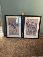 Two framed floral paintings leaning against wall showing full size and frame style.