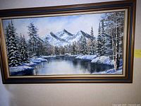Full frontal view of framed mountain landscape painting.