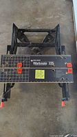 Top view of Black & Decker Workmate 225 portable project center and vise, showing the top surface with measurement markings and red clamp handles.