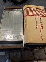 Two Salton Hotray automatic food warmers, one in original box, metal surface with wooden handles