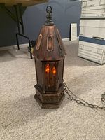 Lantern upright showing hexagonal shape, copper top, wood base