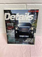 Front cover of 2011 GMC Details magazine featuring GMC Sierra HD truck in black.