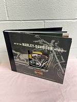 Front cover of Harley-Davidson book showing title and photo of yellow motorcycle.