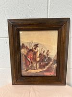 Front view of wooden picture frame with historical print showing figures and horses in period attire.