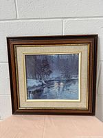 Full view photo of the wooden carved picture frame showing winter river scene print and frame design.