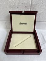 Open wooden case with cream fabric lining and branded Montegrappa Italy imprint inside.