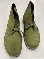 Front view of the green suede leather men's shoes showing laces and toe shape.