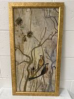 Framed vertical art print featuring two birds perched on branches with muted natural tones and soft textures.