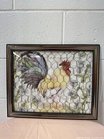 Front view of framed rooster picture with glass and wire mesh overlay