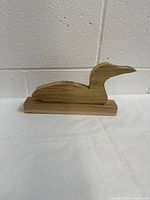 Side view of hand made wooden duck figurine blank showing natural wood grain and shape