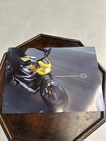 Front cover of Harley-Davidson catalog showing a yellow motorcycle on a road.