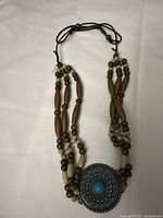 Full view of the Indian style necklace showing the wooden beads and multiple strands.