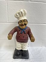 Full body photo of the large chef figurine showing its size and painting