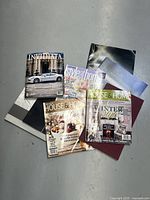 Photo showing a total of six magazines and booklets spread on the floor, mostly Canadian House & Home issues, Style at Home magazine, and an Invidiaata collections booklet