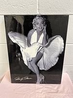 Front view of glossy black and white Marilyn Monroe wall print with signature, showing entire image and condition.