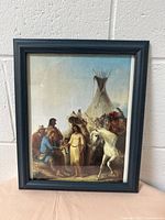 Frontal view of the wooden picture frame with a printed image of Native Americans, a white horse, and a teepee.
