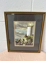 Frontal view of the framed lighthouse picture showing the full image and frame detail.
