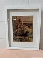 Front view of white wooden picture frame with Native American print inside, showing details of the artwork and frame.