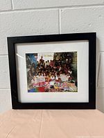 Full view of the black wooden picture frame with a photograph in it.