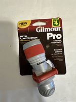 Front view of Gilmour Pro irrigation spray nozzle in original packaging showing branding and product details.