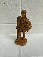 Front view of polymer figurine of a traveler/gold digger standing on a base inscribed 'Gold Digger'