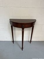 Full view of the Bombay Company Vintage Federal Style Half Moon Table showing semi-circular top and tapered legs