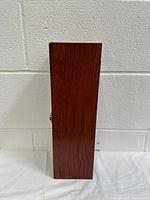 Side view of the wooden wine bottle gift box showing wood grain and silver latch