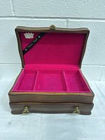Open top lid showing three pink velvet compartments with Princess Royal ribbon inside lid and crown emblem