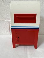 Front view of miniature mailbox showing red mail slot and lockable door under the slot