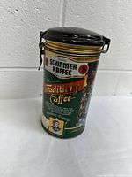 Front view of the Schirmer Kaffee Traditions Caffee coffee tin with brand and text details, hinged lid seen closed.
